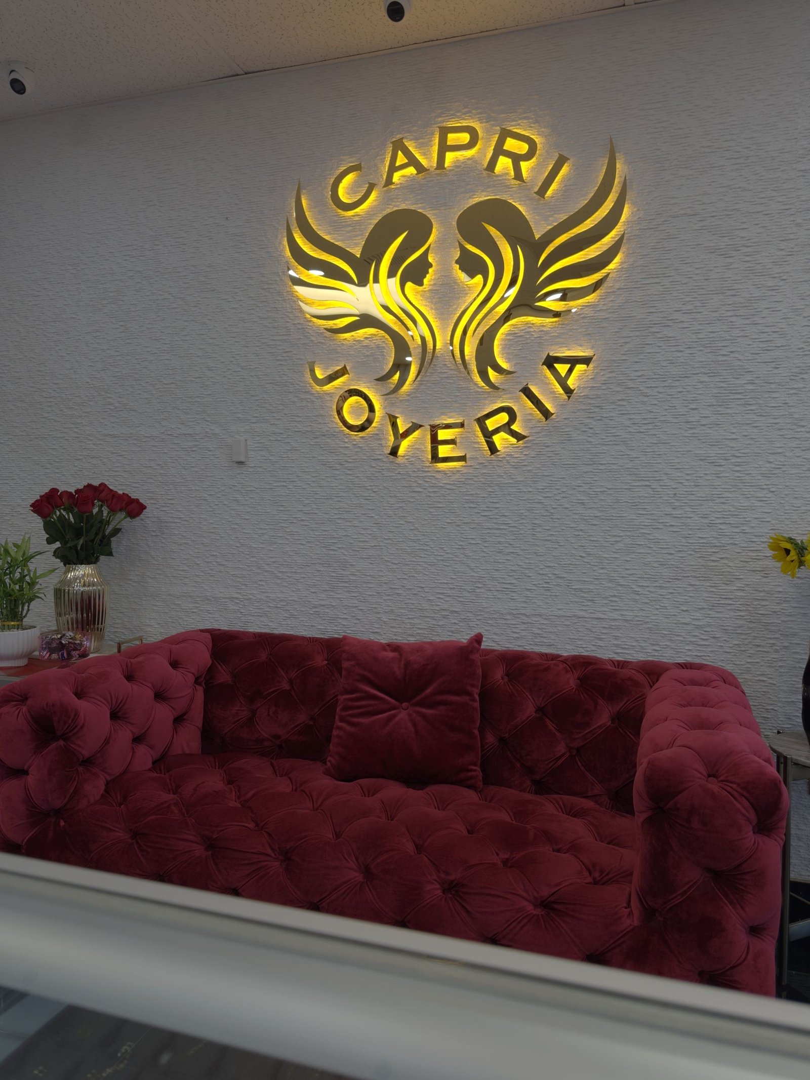 Illuminated gold phoenix logo for Capri Joyeria