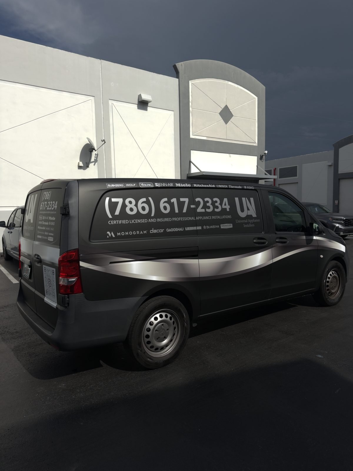 Black Sprinter van partial wrap with large phone number